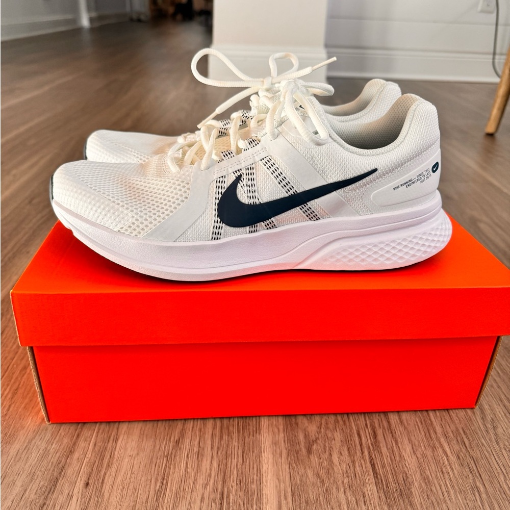 White and navy blue athletic Nike shoes